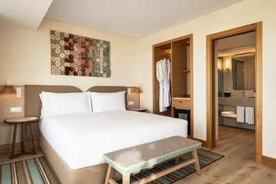 a living room with a couch and a tv at Hyatt Regency Vilamoura Algarve in Vilamoura