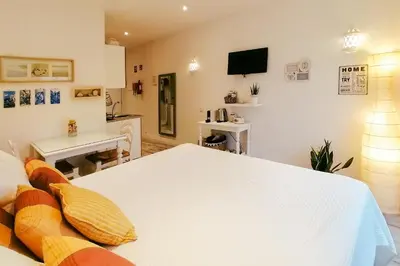 a living room with a white table and a couch at Cosy and Sweet Apartment in Albufeira in Albufeira