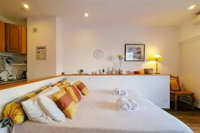 a white bed with pillows and towels on it at Cosy and Sweet Apartment in Albufeira in Albufeira