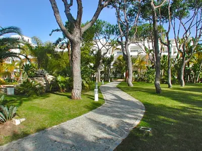 a path through a park with trees and grass at Vale Do Garrao Villas in Vale do Lobo