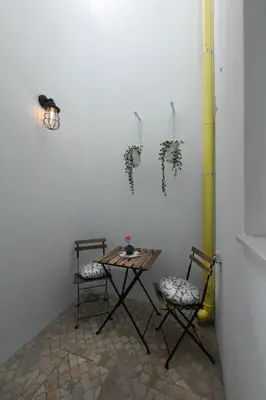 a table and two chairs in a room at DUBOCAGE43 Citycenter in Faro