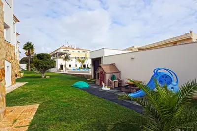 a living room with a table and chairs at Apartamentos Turisticos Novochoro in Albufeira