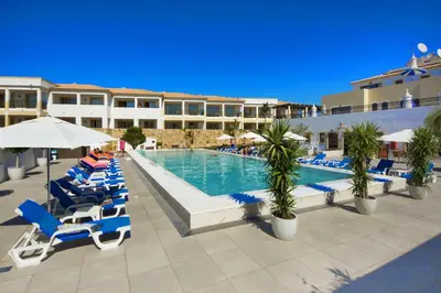 a living room with a table and a couch at Apartamentos Turisticos Novochoro in Albufeira