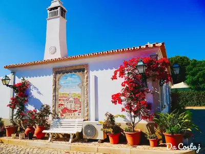 a white table and chairs in a room with a large window at Muthu Balaia Sol in Albufeira