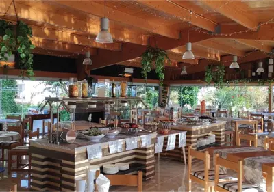 a living room with a glass table and white chairs at Muthu Clube Praia da Oura in Albufeira