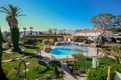a pair of chairs sitting on a porch at Muthu Clube Praia da Oura in Albufeira