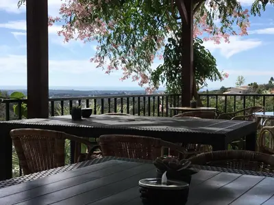 a table and chairs on a deck with a view at Golda Sol in Loulé