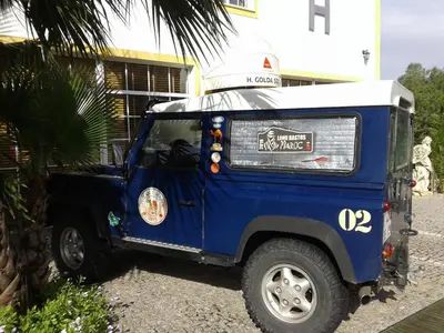 a small blue jeep parked in front of a building at Golda Sol in Loulé