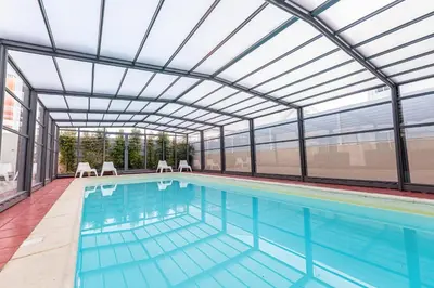 a swimming pool with lounge chairs and a building at Hotel Sao Sebastiao de Boliqueime in Boliqueime