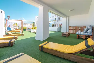a room with several beds on a balcony at Loule Jardim Hotel in Loulé