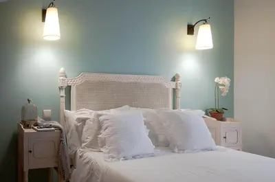 a bedroom with a white bed with white pillows at Hotel Parque das Laranjeiras in Vilamoura