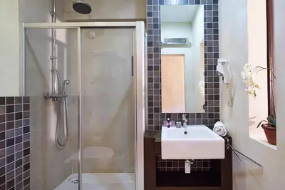 a bathroom with a sink and a shower at Hotel Parque das Laranjeiras in Vilamoura