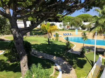 an overhead view of a swimming pool with a tree at Prado Villas in Vilamoura