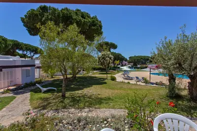 a view of a park with trees and a swimming pool at Prado Villas in Vilamoura