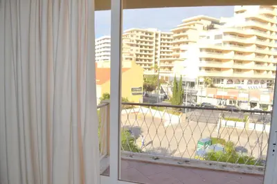 a balcony with a view of a city with buildings at TP Aqua Marina, Vilamoura Triplex Apartment in Quarteira