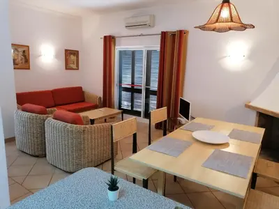 a living room with a couch and a table at Prado do Golf in Vilamoura