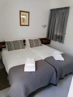 a bedroom with two beds with towels on them at Prado do Golf in Vilamoura