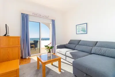 a bedroom with a bed and a desk in a room at Hotel Maritur - Adults Only in Albufeira