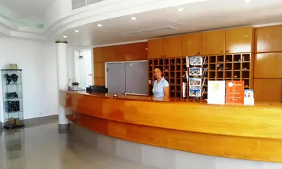 a man standing at a bar in a building at Apartamentos Turisticos Soldoiro in Albufeira
