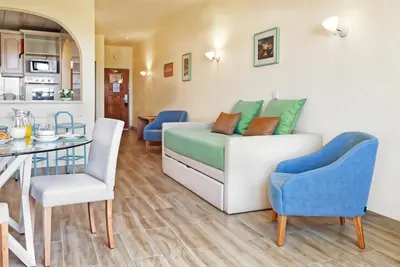 a living room with a couch and a table at Ondamar Hotel Apartamentos in Albufeira