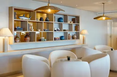 a dining room with white chairs and a table at Dom Jose Beach Hotel (Plus) in Quarteira