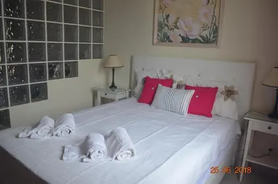 a bedroom with a white bed with towels on it at Vilamoura-Nautic Apartment in Vilamoura