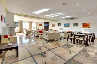 a large living room with tables and chairs at Zodiaco in Quarteira