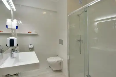 a bathroom with a toilet and a sink and a shower at Zodiaco in Quarteira