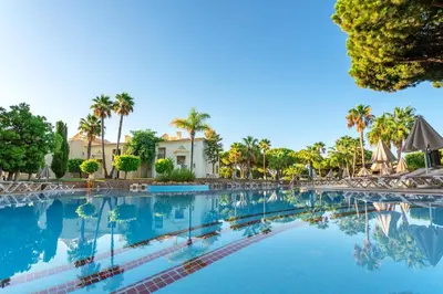 a restaurant with a dining room with tables and chairs at AP Adriana Beach Resort in Albufeira