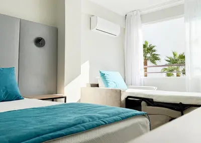 a hotel room with a bed and a window at Hotel Atismar in Quarteira