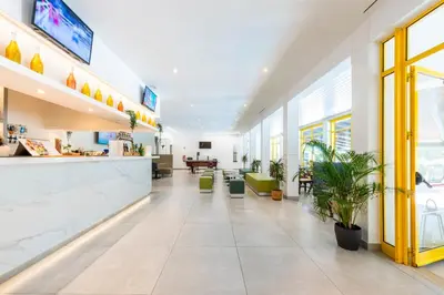 a lobby of a hospital with a waiting room at Hotel Pinhal do Sol in Quarteira
