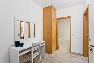 a white room with a desk and a mirror at Vale San Antonio Apartments in Almancil
