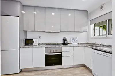a white kitchen with white cabinets and a microwave at Vale San Antonio Apartments in Almancil