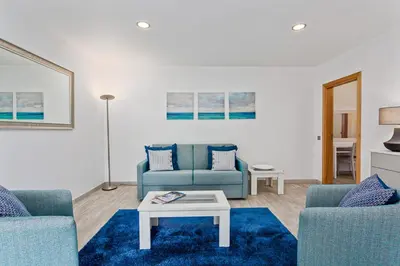 a living room with two blue couches and a table at Vale San Antonio Apartments in Almancil