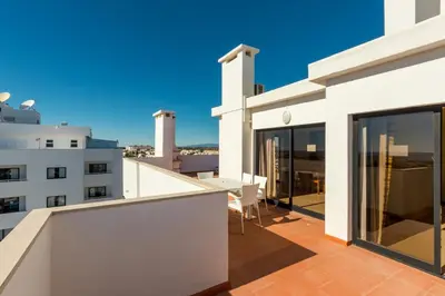 a balcony with a view of a building at Janelas do Mar Apartamentos Turisticos in Albufeira