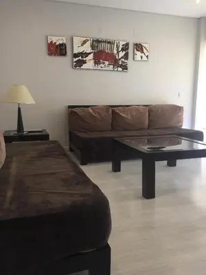 a living room with a couch and a coffee table at Parque Mourabel, Oásis Village & Pé do Lago in Vilamoura