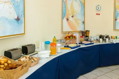 a long blue table with food and baskets of food at Club Ouratlantico in Albufeira