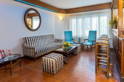 a living room with a couch and chairs and a table at Hotel Mar A Vista in Albufeira