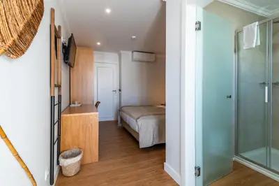 a hotel room with a bed with orange pillows at Vila Sao Vicente Boutique (Adults Only) in Albufeira