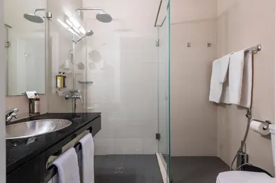 a bathroom with a toilet and a bedroom with a bed at Vila Sao Vicente Boutique (Adults Only) in Albufeira