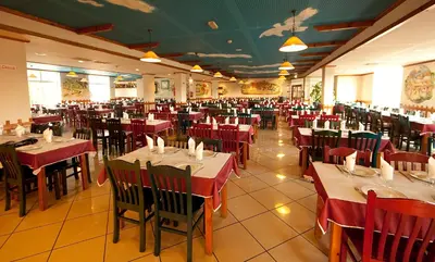 a dining room with red tables and chairs at Hospedaria Frangaria in Faro