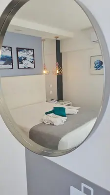 a bedroom with a bed in a mirror at Rocamar Exclusive Hotel & Spa - Adults Only in Albufeira