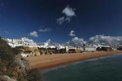 a view of a beach with hotels and buildings at Rocamar Exclusive Hotel & Spa - Adults Only in Albufeira