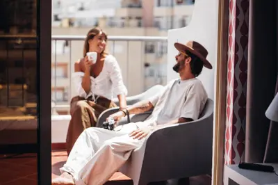 a man and a woman sitting on a balcony at Stay Hotel Faro Centro in Faro