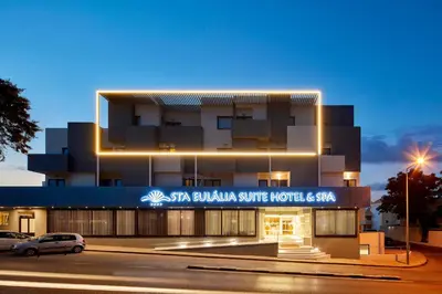 a bedroom with a large bed and a desk at Santa Eulalia Hotel & Spa in Albufeira
