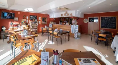 a restaurant with tables and chairs in a room at Vila Petra in Albufeira