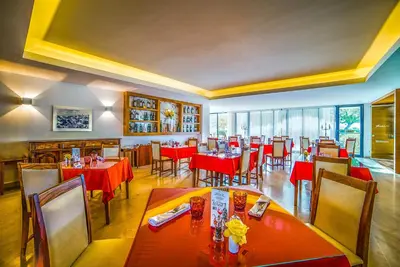 a restaurant with tables and chairs with red table cloth at Vila Petra in Albufeira