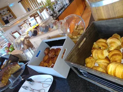 two boxes of pastries are sitting on a table at Vila Petra in Albufeira