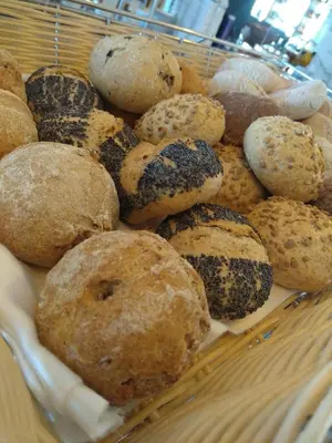 a basket filled with lots of different types of muffins at Vila Petra in Albufeira