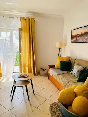 a living room with a couch and a table at Seashell Apartment OURA in Albufeira